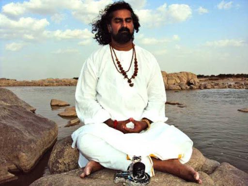 Mohanji meditating in front of a small Shiva Linga