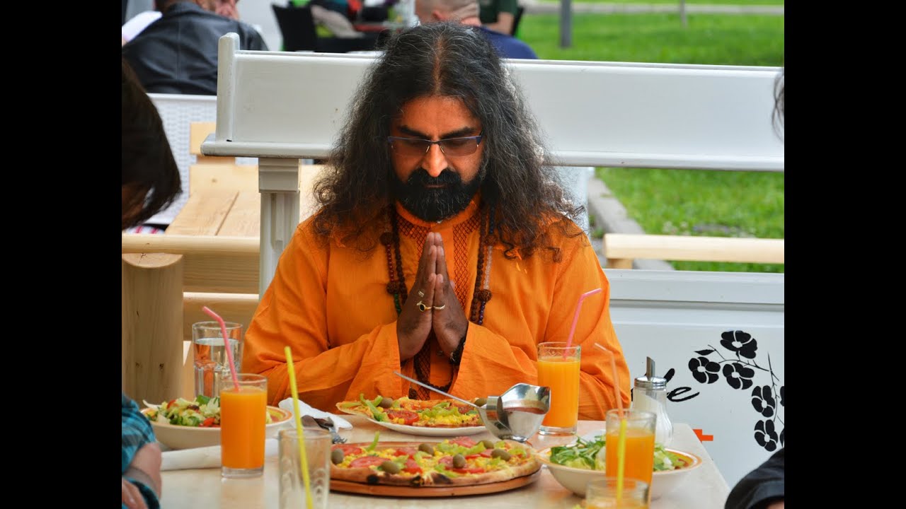 Photograph of Mohanji  praying before eating